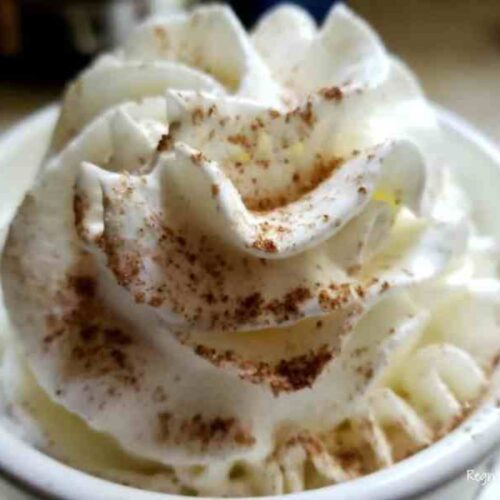 cup of coffee with whipped cream in a white mug