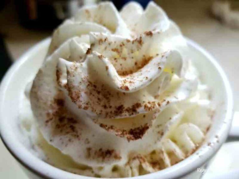 cup of coffee with whipped cream in a white mug