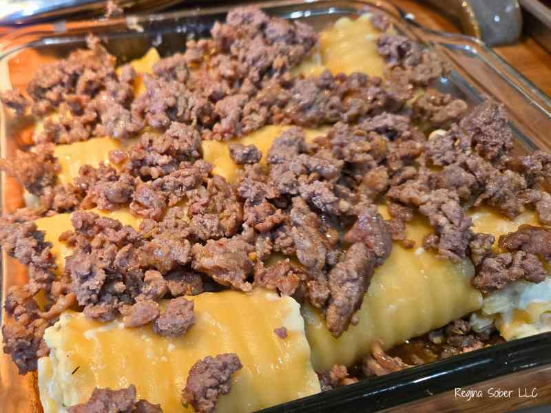 browned meat on top of lasagna noodles