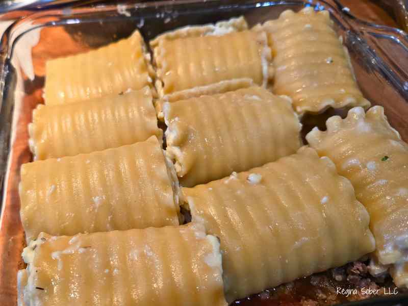 rolled lasagna noodles with parmesan cheese, parsley and ricotta cheese