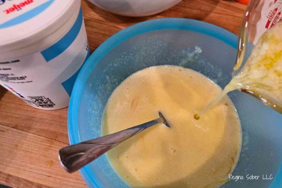 mixing cooled melted butter into the egg sugar mixture