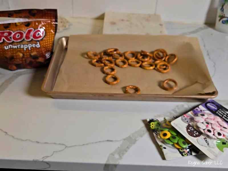 round preztzels with rolos and eye balls on baking sheet