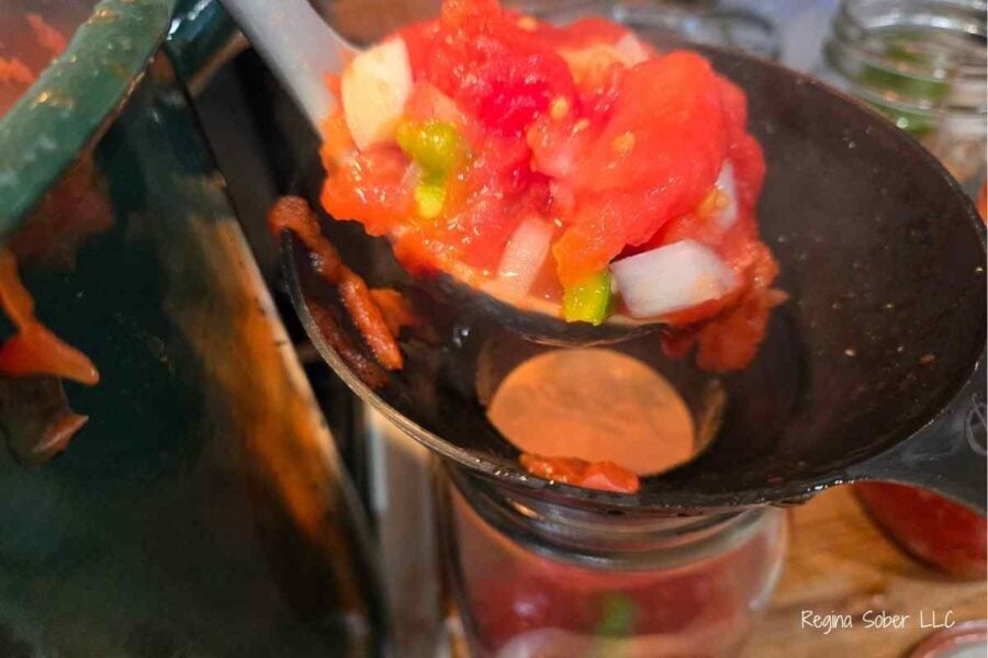 filling quart jars with stewed tomatoes leaving 1 inch head space
