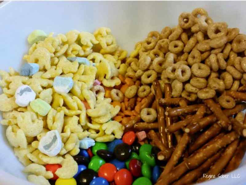 bowl of dry cereal with pretzels and chocolate candies
