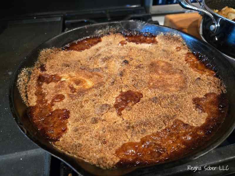 baking peach cobbler carmalized the sauce darkening it into a rich flavor.