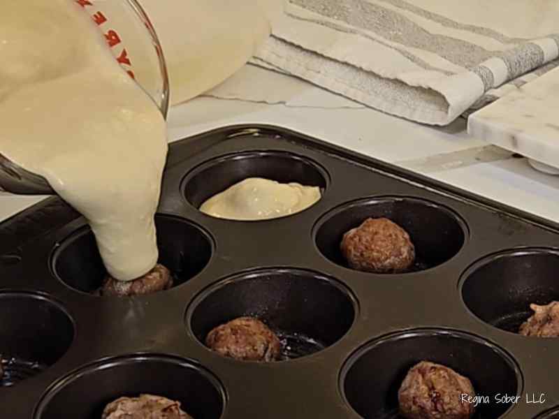 pancake batter over mini cooked sausages