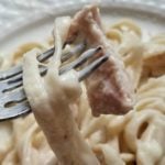 chicken alfredo on a fork