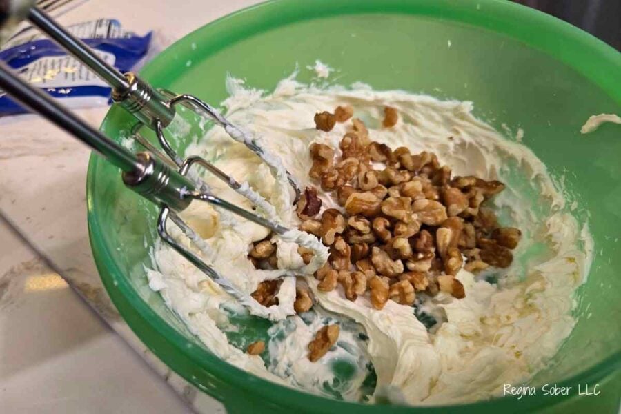 mixing all the flavors together to make walnut cream cheese