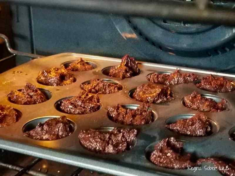 brownie batter in muffin tin in oven