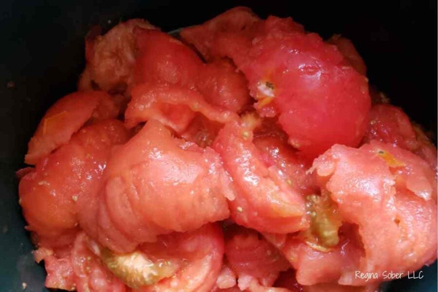 peeled whole tomatoes in canning pot