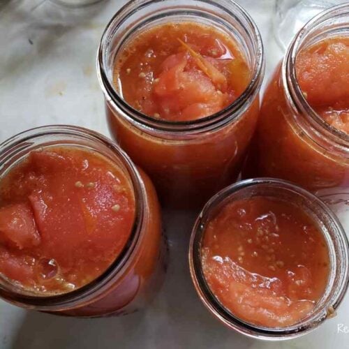 jarred tomatoes that are crushed and ready to be processed