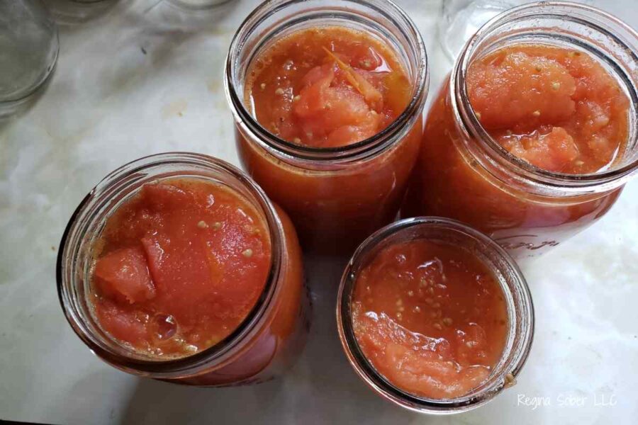 jarred tomatoes that are crushed and ready to be processed