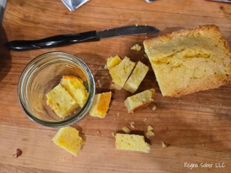 cutting pound cake into cubes to fit into the cute jars