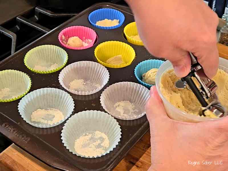scooping dough into cupcake liners