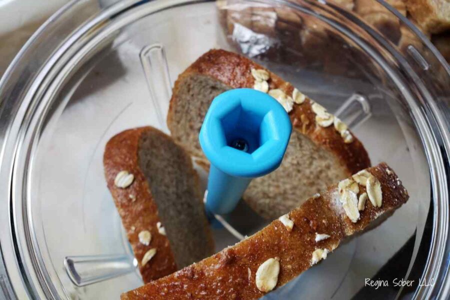 slices of bread in container to crumble