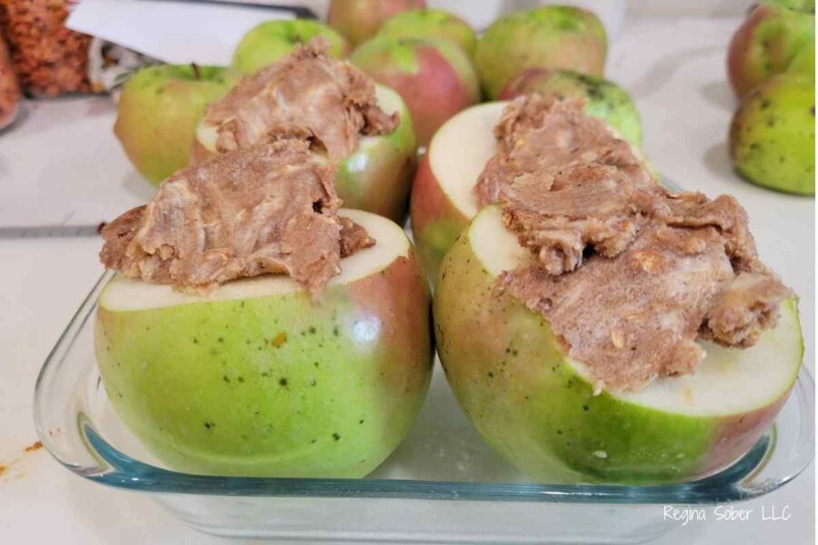 apples stuffed with crisp mixture in a pan