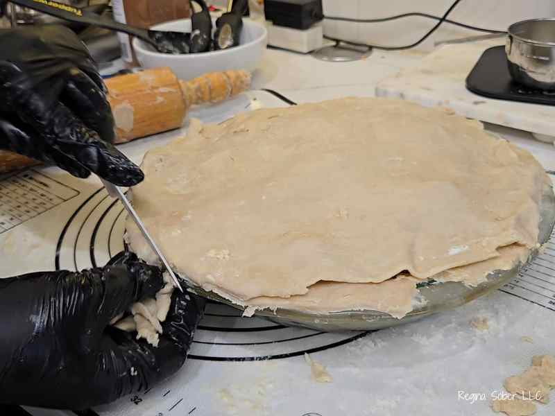 trimming pie crust with knife