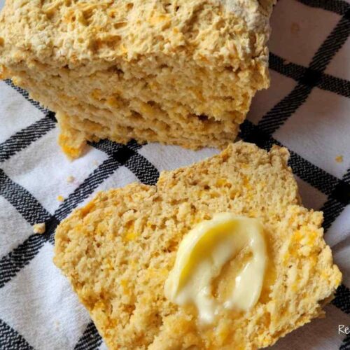 slice of beer cheese bread with a dollop of butter