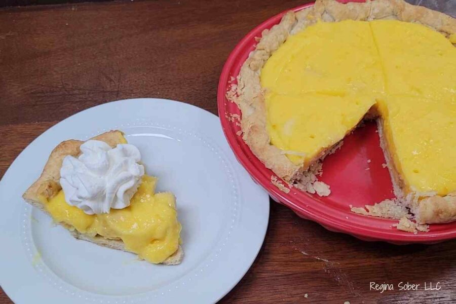 plated slice of homemade banana cream pie with whipped cream