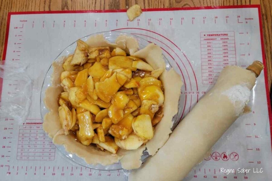 traditional apple pie with caramel sauce in homemade pie crust