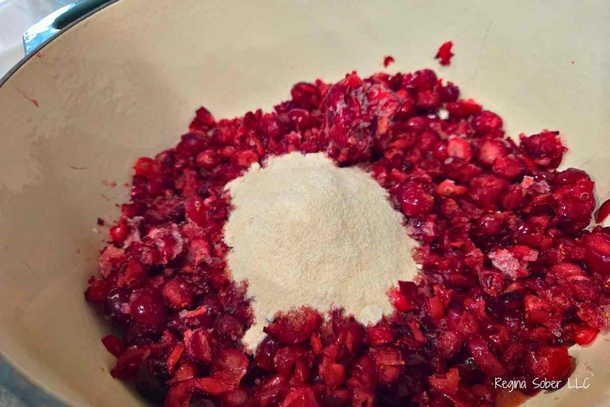 Cranberries, strawberies and pectin in dutch oven