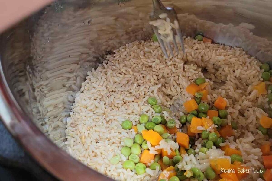 cooked rice fluffing with a fork