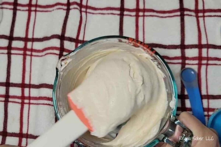 mixing bowl with creamy fruit dip with spatula