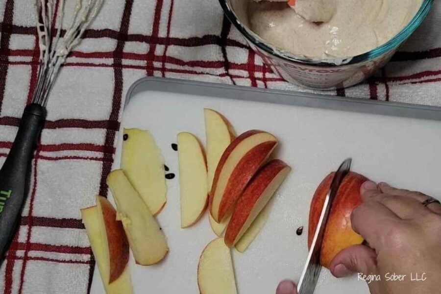 slicing apples on cutting board with knife