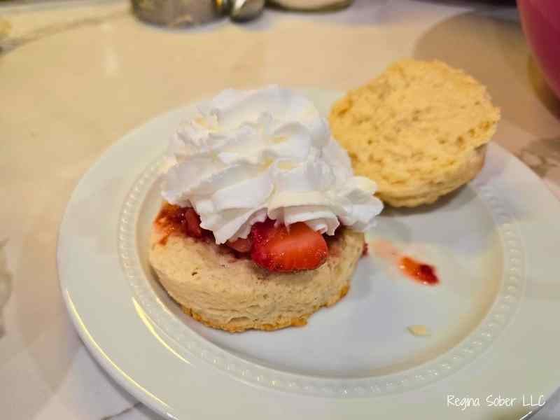 adding whipped cream inside the biscuits and topping the strawberries for an extra layer of flavor
