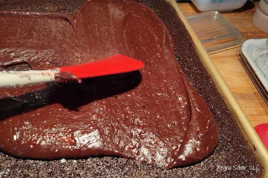 spreading frosting while its hot on the warm cake