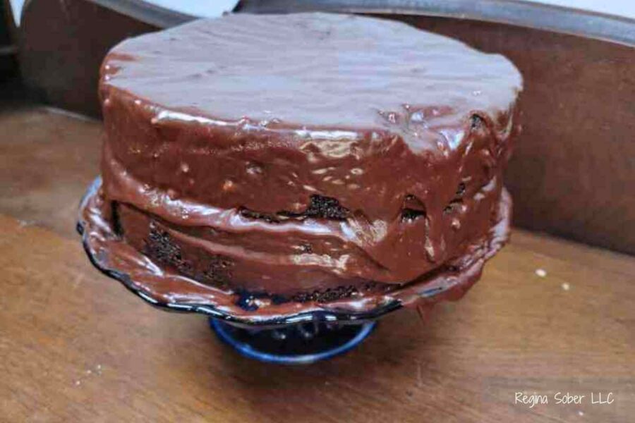 two tiered chocolate cake on pedestal
