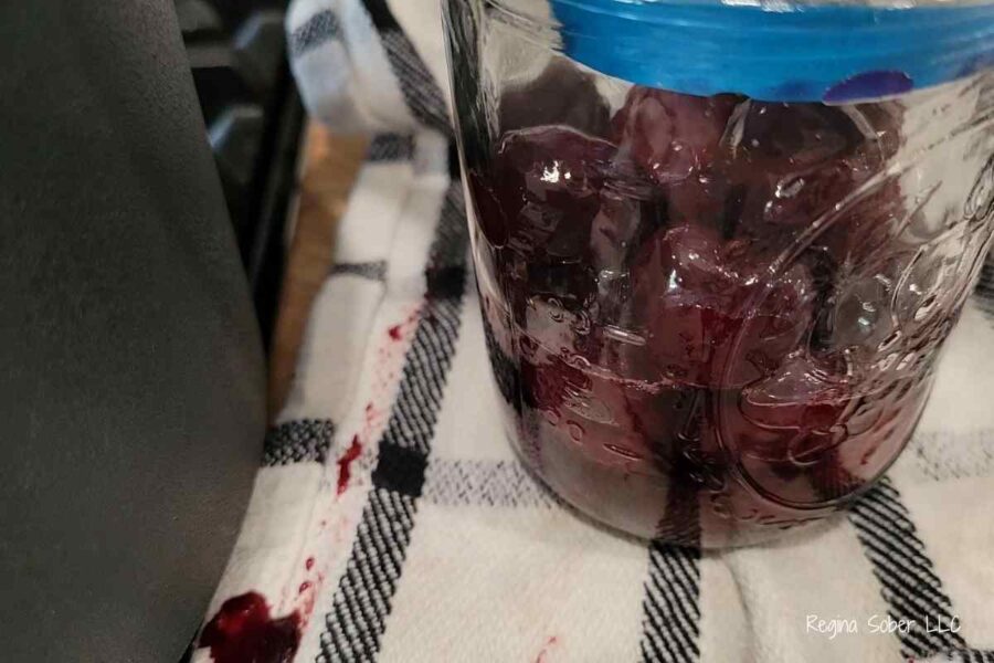 ladle with soaked cherries waiting to go in a jar