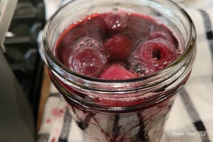 pint jar of cherries with hot liquid
