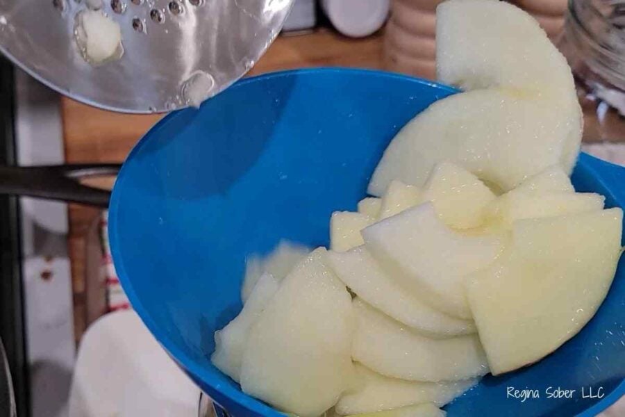home canned apple slices placed in jar