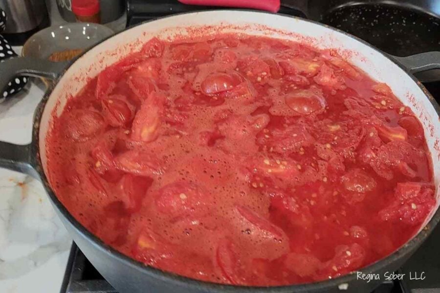 dutch oven with peeled tomatoes and tomato pulp