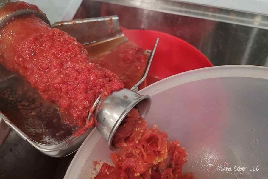 tomato puree on the food mill while juicing tomatoes