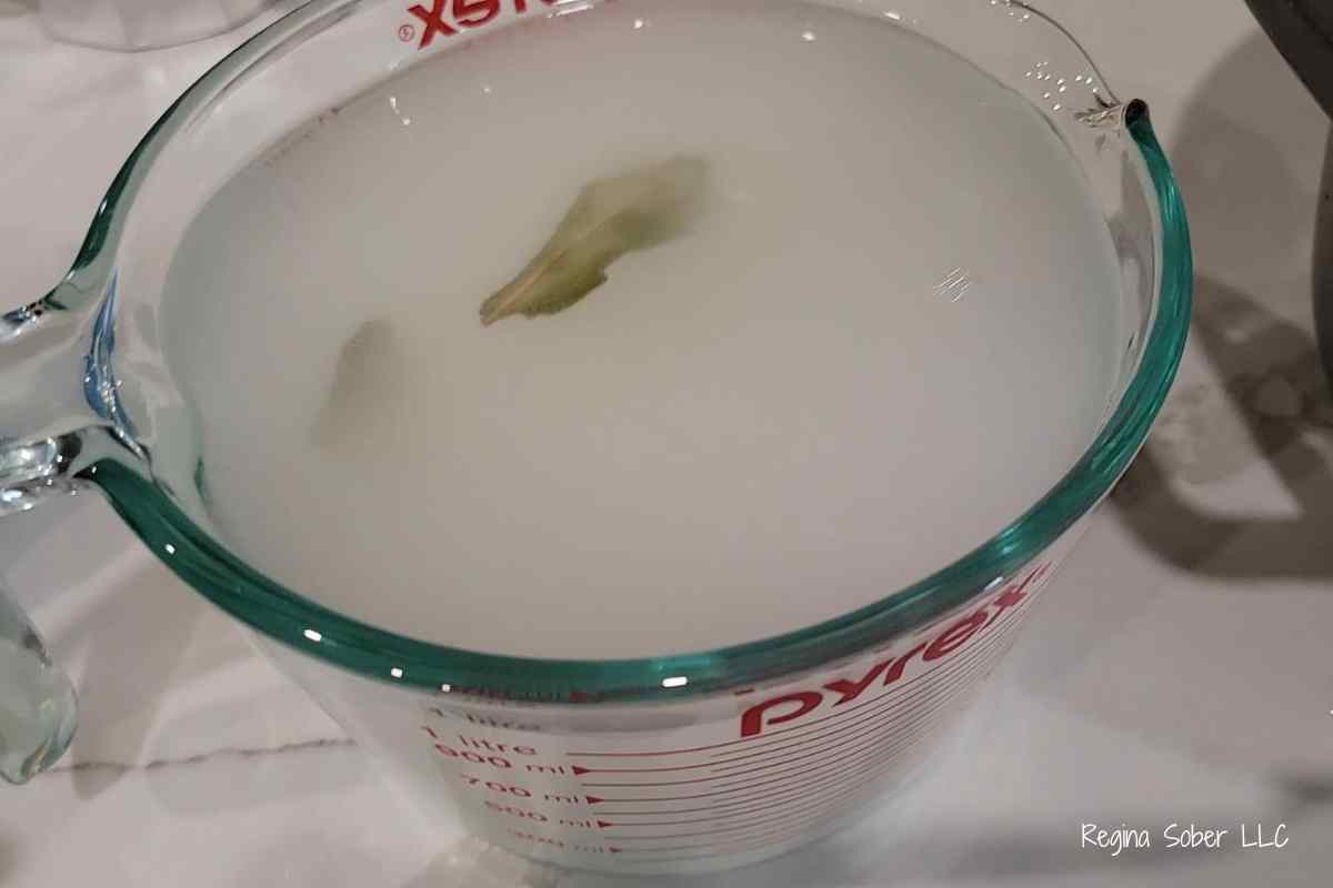 turkey brine recipe with bay leaves in large measuring cup with canning