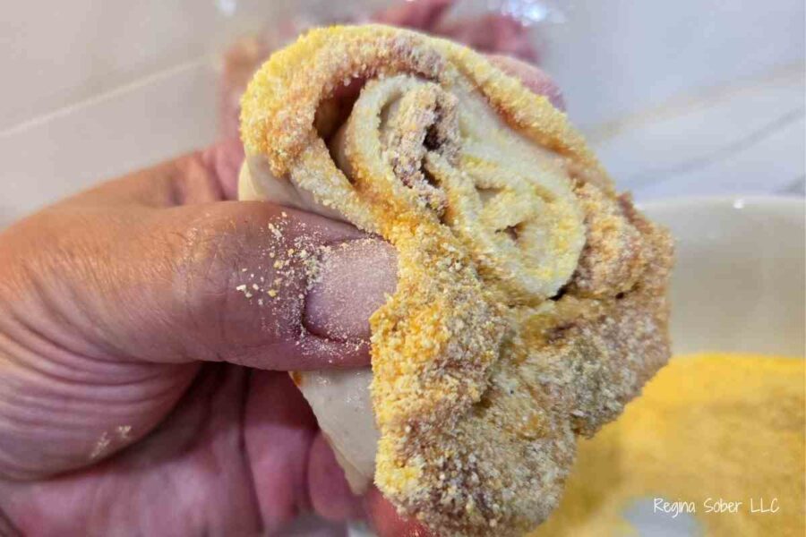 coat bottom of rolls with cornmeal and they won't stick to the pan