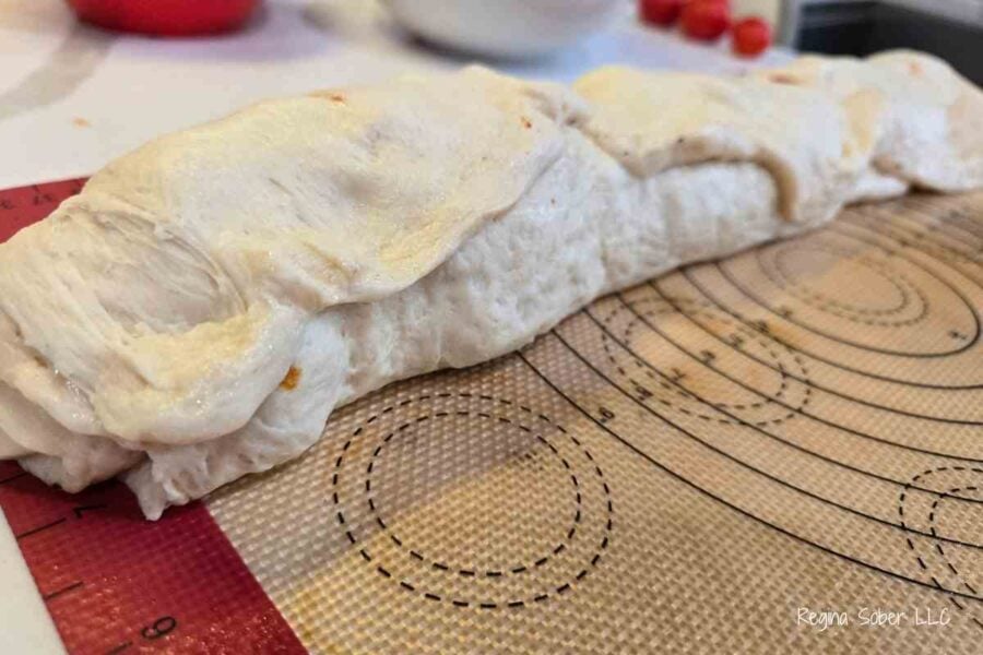 roll pizza dough like a cinnamon roll and crimp edge to roll