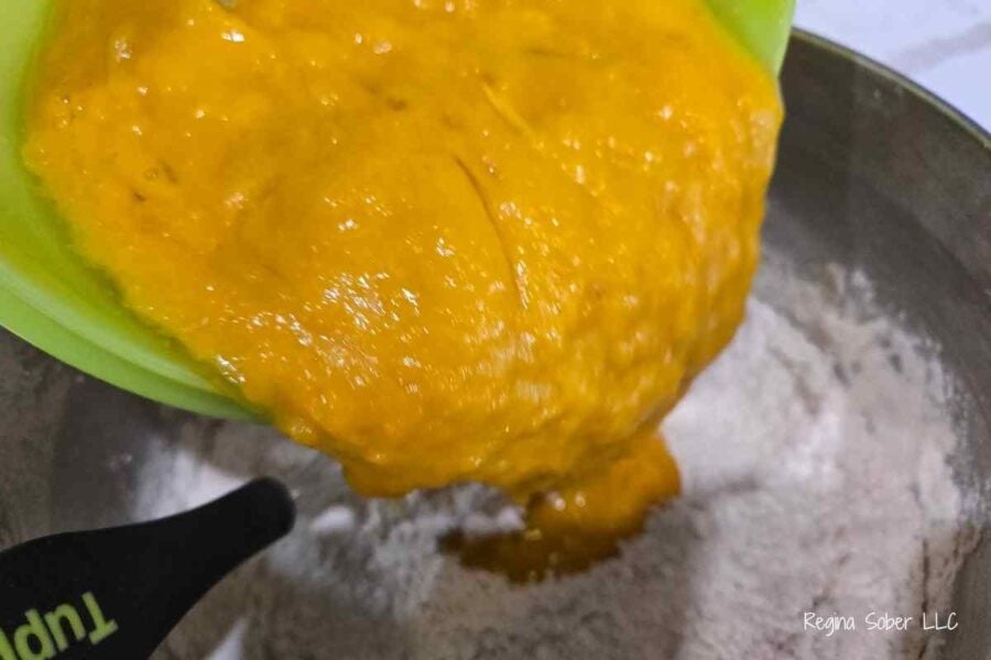 adding the wet into the dry for the perfect pumpkin bundt cake