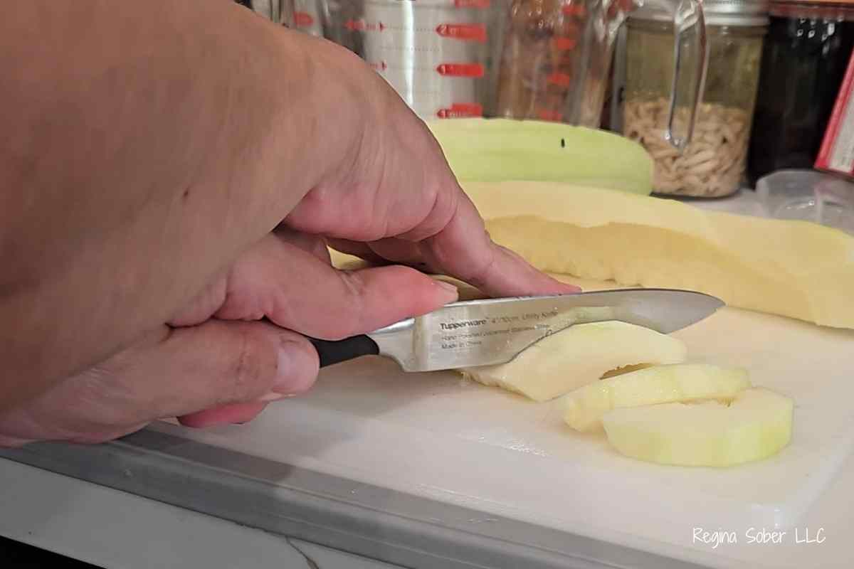 slice zucchini with knife and cutting board