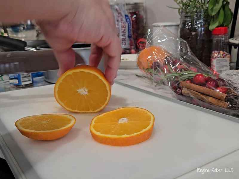slicing fresh oranges on cutting board