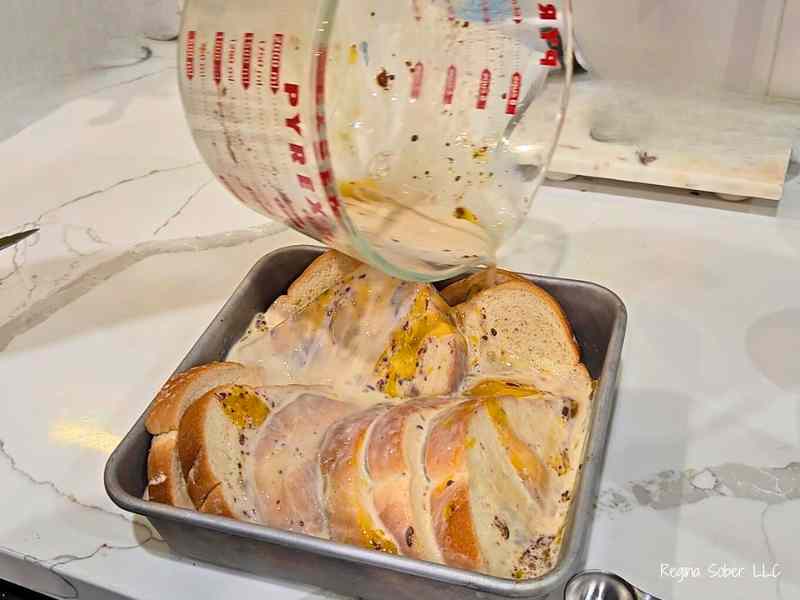 eggs poured over toast in baking pan