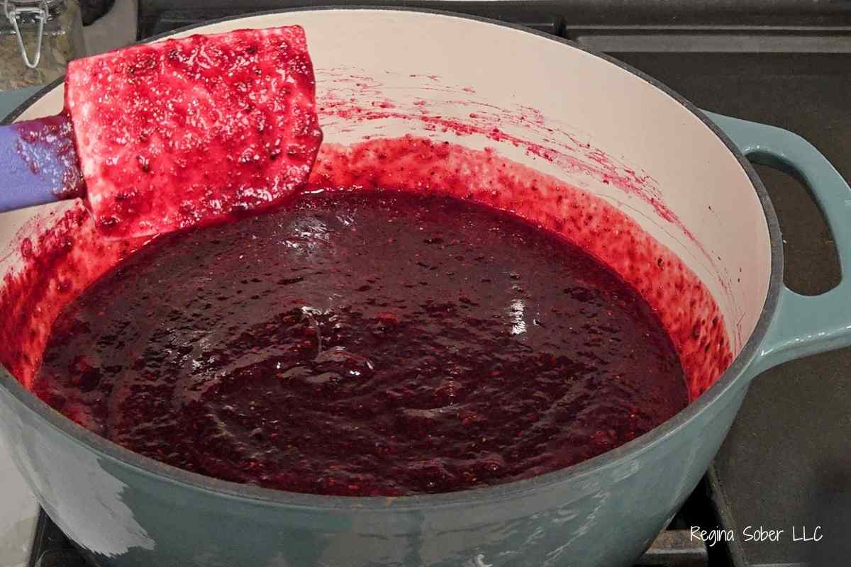 stirring the jam so it does not burn in the pot