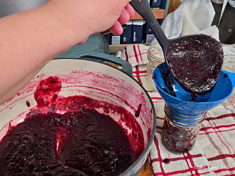 pouring jam into half pint jars