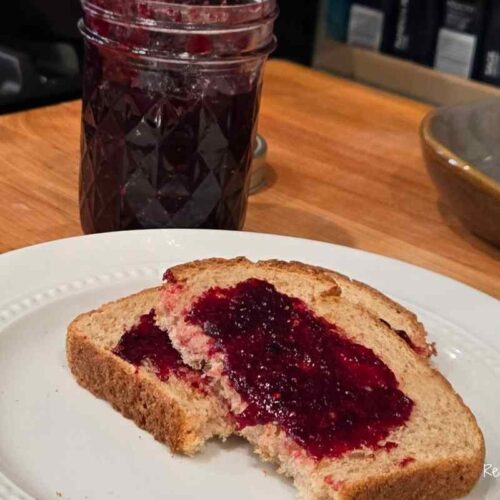 mixed berry jam on toast with a jar of jam