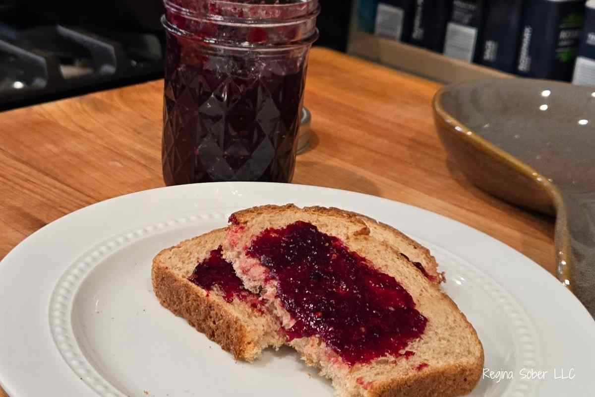 mixed berry jam on toast with a jar of jam