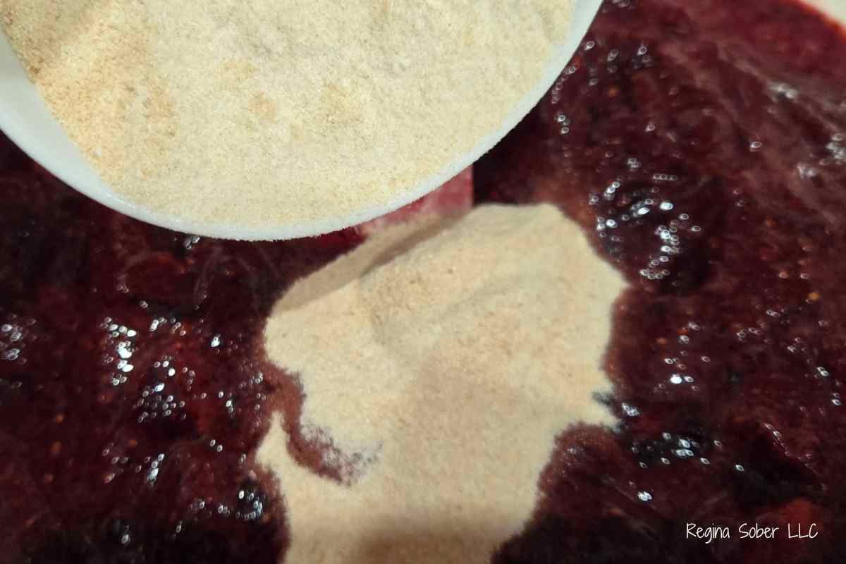 adding pectin into mixed berry jam