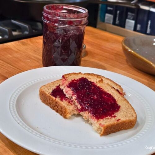 mixed berry jam on toast with a jar of jam