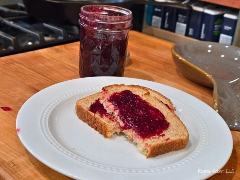 mixed berry jam on toast with a jar of jam
